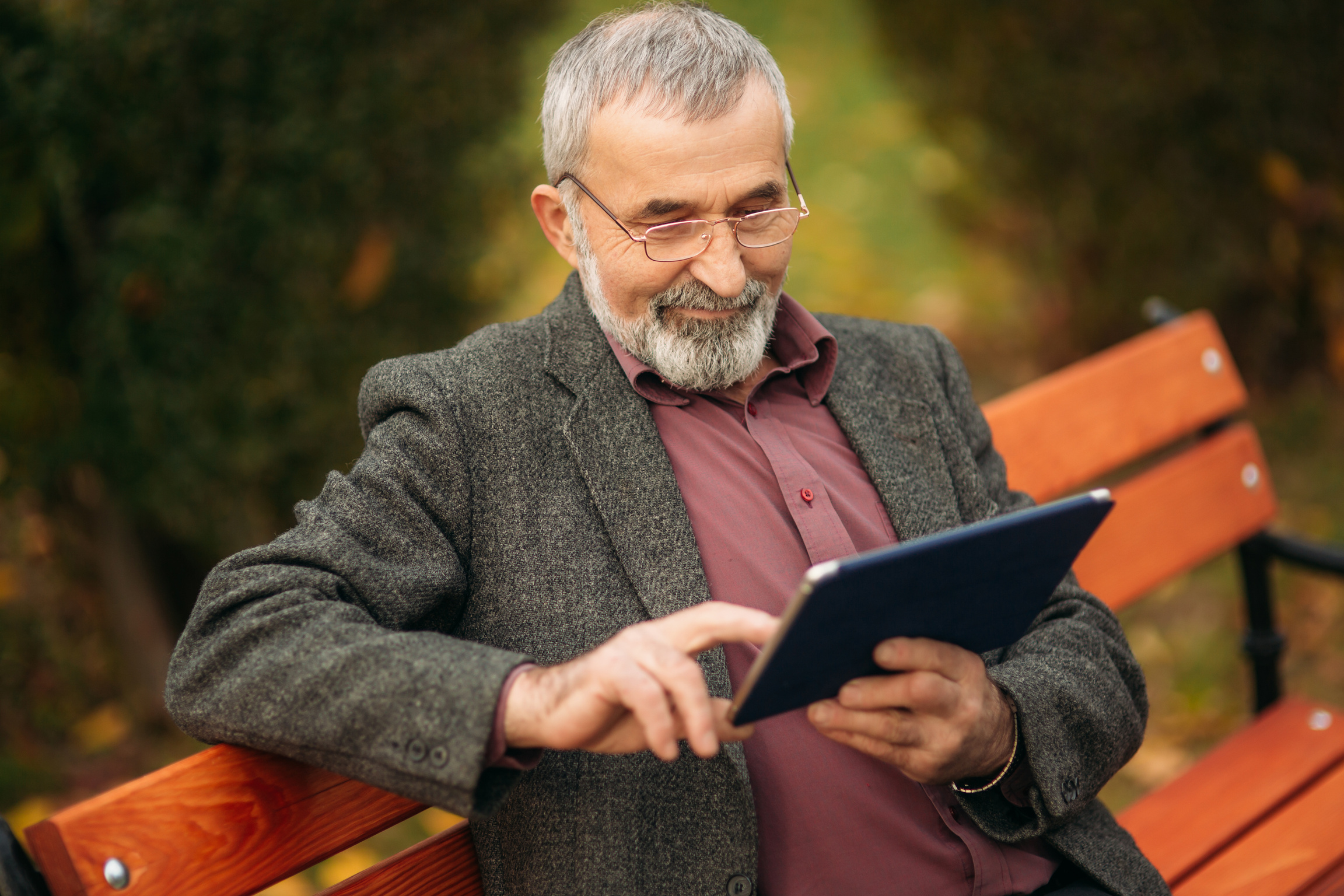 Grandpa Using Tablet in the Park 